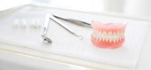 Set of full dentures on surgical table
